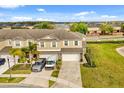 Aerial view of a multi-Gathering home with lush landscaping and ample parking space at 15143 Pacey Cove Dr, Orlando, FL 32824