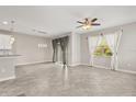 Bright living area with tiled floors, contemporary lighting, and views of landscaped yard at 15143 Pacey Cove Dr, Orlando, FL 32824