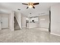 Spacious open-concept living area features tiled floors, stairs and modern lighting at 15143 Pacey Cove Dr, Orlando, FL 32824