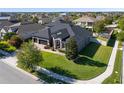 Aerial view of a gray house with a manicured lawn and a three-car garage at 16003 Tangerine Blossom Way, Winter Garden, FL 34787