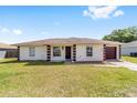 Charming single-story home with well-maintained lawn, inviting curb appeal, and a one car garage at 177 Larch Rd, Ocala, FL 34480