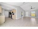 Open-concept kitchen featuring modern appliances and cabinetry adjacent to a bright, spacious living area at 177 Larch Rd, Ocala, FL 34480