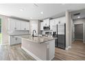 Modern kitchen with white cabinets, stainless steel appliances, and a granite-topped center island at 18 Pine Pass Ln, Ocala, FL 34472