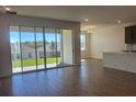 Open-concept living room features tile floors, lots of light and a sliding glass door to the backyard at 2296 Sirena Ln, Mount Dora, FL 32757