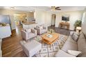 Inviting living room with modern furniture, neutral colors, and light wood-look floors at 2318 Vincent Rd, Orlando, FL 32817