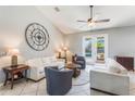 Bright living room with neutral tones, tile floors, and view of the pool at 2361 Baker Ave, Orlando, FL 32833
