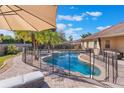 Backyard swimming pool and jacuzzi spa surrounded by brick pavers, privacy fence, and tropical landscaping at 2361 Baker Ave, Orlando, FL 32833
