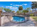 Sparkling pool with safety fence, surrounded by pavers and lush landscaping at 2361 Baker Ave, Orlando, FL 32833