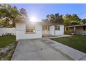 Inviting single-story home with a driveway and green lawn, perfect for suburban living at 241 S Marydell Ave, Deland, FL 32720