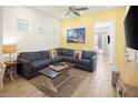 Comfortable living room featuring a large sectional sofa, nautical decor, and lots of natural light at 2967 Latitude Ln, Kissimmee, FL 34747