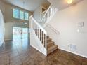 Spacious foyer with tile flooring, staircase, and view of the backyard pool at 358 Morning Creek Cir, Apopka, FL 32712