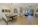 Spacious living area featuring wood floors and a view of the screened-in pool at 419 Coventry Rd, Davenport, FL 33897