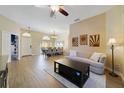 Bright and open living area with wood floors and a dining area at 419 Coventry Rd, Davenport, FL 33897