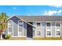 Apartment building with gray paint, arched windows, and gray roof at 4314 Pershing Pointe Pl # 4, Orlando, FL 32822