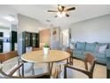 Bright living room with a ceiling fan, a light blue couch, and a wooden dining table at 4314 Pershing Pointe Pl # 4, Orlando, FL 32822