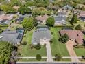 An aerial view of a single-Gathering home featuring a screened pool and lush green lawn in a residential neighborhood at 504 Sonata Ct, Winter Springs, FL 32708