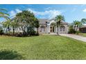 Attractive single-story home featuring a well-maintained lawn, stone accents, mature trees, and an arched entry at 504 Sonata Ct, Winter Springs, FL 32708