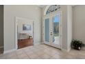 Bright foyer with tile flooring, double front doors with glass panels, and an open view of a study at 504 Sonata Ct, Winter Springs, FL 32708