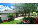 Beautiful backyard with stone patio, artificial turf and well placed landscaping at 5123 Santa Ana Dr, Orlando, FL 32837