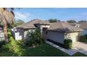 Aerial view of a cozy single-Gathering home featuring lush landscaping and a neatly maintained lawn at 5123 Santa Ana Dr, Orlando, FL 32837