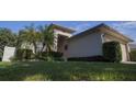 Beautiful single-Gathering home featuring a well-manicured lawn, mature landscaping, and an inviting front entrance at 5123 Santa Ana Dr, Orlando, FL 32837