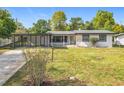 Charming single story home with a well-maintained lawn, carport, and front porch at 533 Baxter St, Orlando, FL 32806