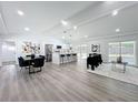 Open concept living space with modern gray floors, and a dining and kitchen area at 533 Baxter St, Orlando, FL 32806