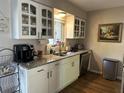 Bright kitchen featuring updated cabinetry, granite countertops, and modern appliances at 58 Magnolia Dr, Debary, FL 32713