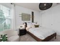 Serene bedroom offering a comfortable bed, a wardrobe and natural light at 6032 Tree Crossing Ln, St Cloud, FL 34771