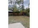 The backyard featuring lush greenery and a mix of trees, plants and a wooden fence at 6130 Gamble Dr, Orlando, FL 32808