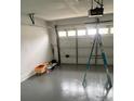 A spacious garage with a white door, offering ample space for storage and vehicle parking at 6130 Gamble Dr, Orlando, FL 32808