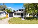 Inviting exterior showcasing a cozy single Gathering home with a well-maintained lawn and adjacent garage at 819 State Ave, Daytona Beach, FL 32117