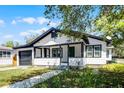 Home exterior displaying front porch and entry with lush yard at 819 State Ave, Daytona Beach, FL 32117