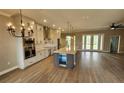 Bright kitchen featuring white cabinets, stainless steel appliances, a large island, and wood-look tile flooring at 947 Ferne Dr, Longwood, FL 32779