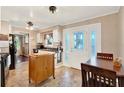 Bright kitchen featuring white cabinets, tile flooring, breakfast nook, and a decorative glass door at 105 Canal Vw, Eustis, FL 32726