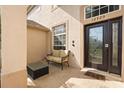 Inviting front porch with neutral furniture and direct access to front door at 12720 Greco Dr, Orlando, FL 32824