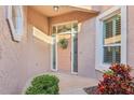 Inviting front entrance with a decorative wreath and manicured landscaping at 14336 Dulcimer Ct, Orlando, FL 32837