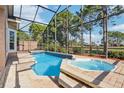 Relaxing screened-in pool and spa area, surrounded by lush landscaping at 14336 Dulcimer Ct, Orlando, FL 32837