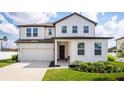 Inviting two-story home with a modern design, beautiful landscaping, and an attached two-car garage at 1639 Meadowlark Dr, Deltona, FL 32725