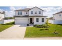Charming two-story home with a well-manicured lawn and driveway, featuring modern architectural details at 1639 Meadowlark Dr, Deltona, FL 32725
