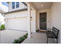 Inviting front porch with stylish bench, plants and charming door wreath, leading to a well-maintained home at 1639 Meadowlark Dr, Deltona, FL 32725
