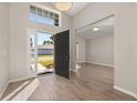 Inviting foyer showcasing wood-look tile flooring, an open doorway and plenty of natural light at 165 Margate Dr, Davenport, FL 33897