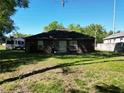 Backyard featuring lush green grass, bordered by mature trees, and offering privacy and tranquility at 1931 Clarcona Rd, Apopka, FL 32703