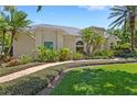 Beautifully landscaped home featuring a brick walkway and mature palm trees at 2140 Lilypad Ln, Windermere, FL 34786
