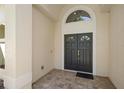 Elegant double front door with an arched transom window and brick entryway at 2140 Lilypad Ln, Windermere, FL 34786