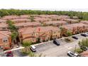 Aerial view of the townhomes featuring red tile roofs and manicured landscaping at 2653 Roadster Ln, Kissimmee, FL 34746