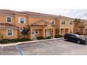 Charming two-story townhome with a red tile roof and manicured landscaping at 2653 Roadster Ln, Kissimmee, FL 34746