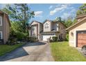 Charming two-story home with landscaped front yard and a driveway with basketball hoop at 452 Opal Ct, Altamonte Springs, FL 32714