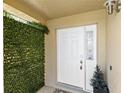 Inviting front door entrance with clean white trim and accenting green wall at 459 Tivoli Cir, Davenport, FL 33837