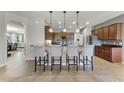 Spacious kitchen with bar seating, stainless steel appliances, and tiled backsplash at 4631 Cypress Forest Ln, St Cloud, FL 34772